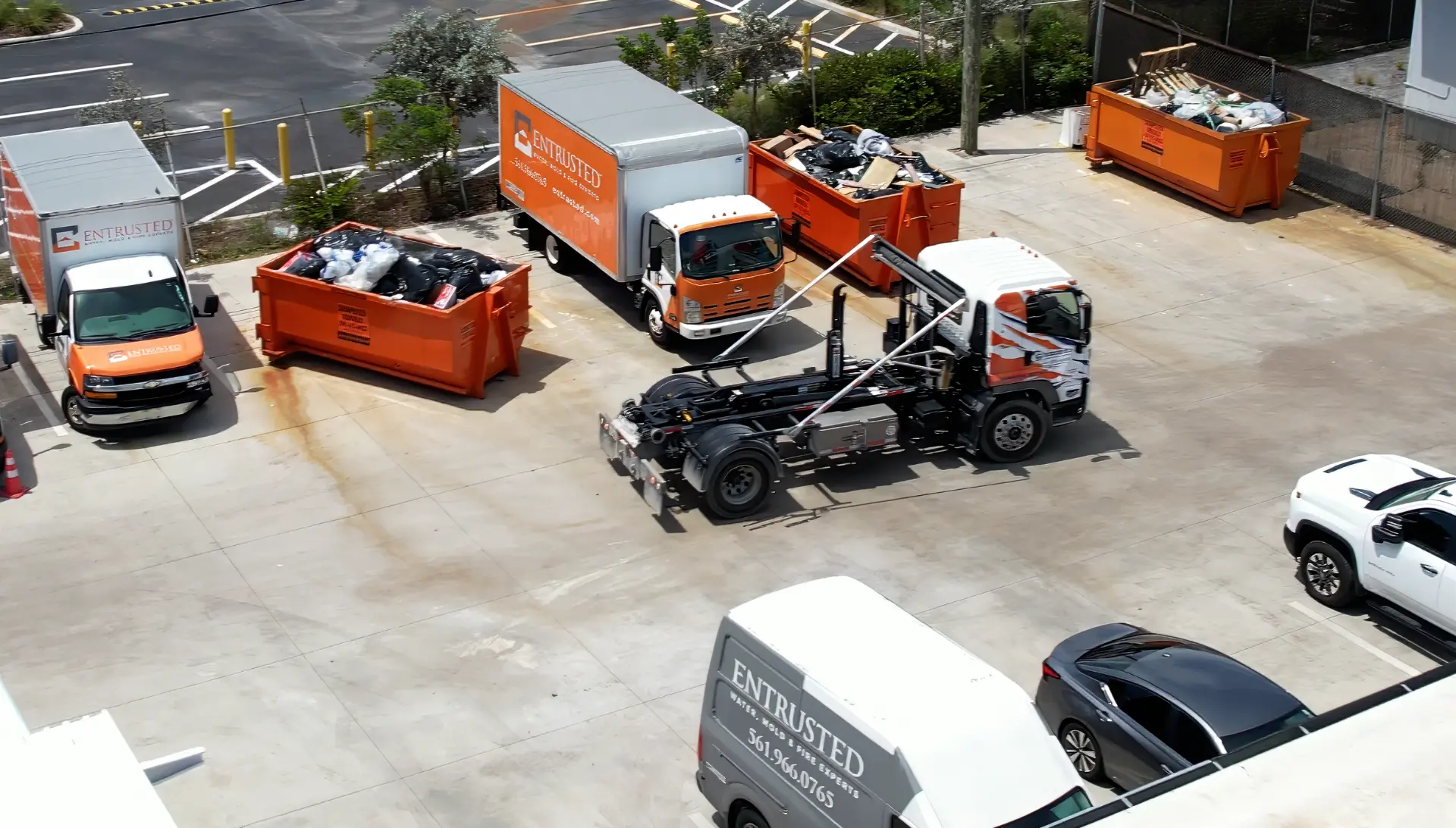 Three Sabatello roll-off dumpsters placed permanently at a trade company yard